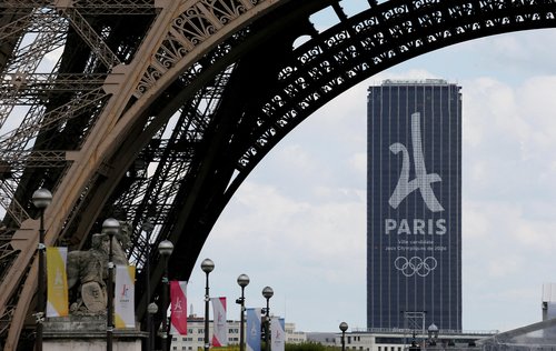 FILE PHOTO: The logo of the Paris candidacy for the 2024 Olympic and Paralympic Games is seen on the Montparnasse tower behind the Eiffel Tower in Paris
