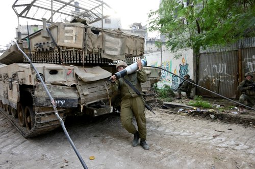 Israeli soldiers operate at the Shajaiya district of Gaza city amid the ongoing conflict between Israel and the Palestinian Islamist group Hamas, in the Gaza Strip
