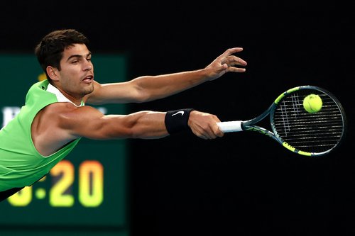 Spain's Carlos Alcaraz hits a return to Serbia's Novak Djokovic during their men's