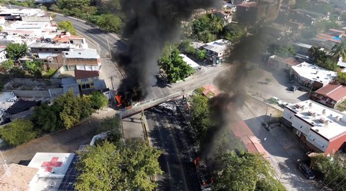 Smoke billows from burning vehicles amid a wave of violence, with torched vehicles and gunmen blocking highways in more than half a dozen states, following a military operation in which a government source said Mexican drug lord Nemesio Oseguera, known as