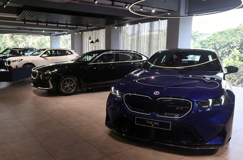FILE PHOTO: Cars are displayed inside a BMW showroom in Mumbai,
