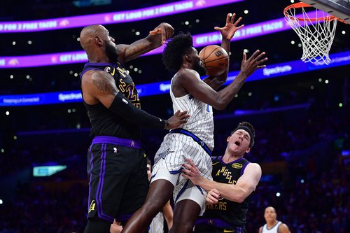 Feb 24, 2026; Los Angeles, California, USA; Orlando Magic forward Jonathan Isaac (1) collides with Los Angeles Lakers guard Austin Reaves (15) as forward LeBron James (23) defends during the first half at Crypto.com Arena. Mandatory Credit: Gary A. Vasque