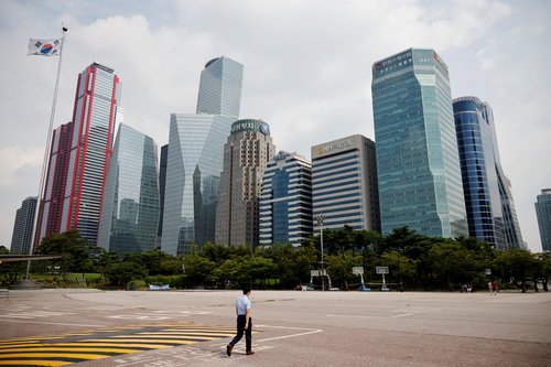 An employee walks at an empty park near a financial district amid the coronavirus disease (COVID-19) pandemic in Seoul, South Korea,
