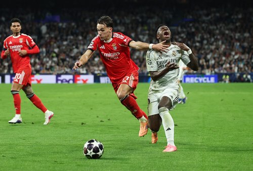 Soccer Football - UEFA Champions League - Play Off - Second Leg - Real Madrid v Benfica - Santiago Bernabeu, Madrid, Spain - February 25, 2026 Real Madrid's Vinicius Junior in action with Benfica's Amar Dedic Dedić Amar