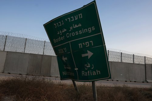 A damaged road sign stands at the Kerem Shalom border crossing, as military operations continue in the southern Gaza city of Rafah, at an area outside Kerem Shalom