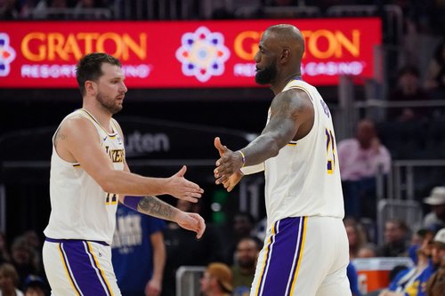 Feb 28, 2026; San Francisco, California, USA; Los Angeles Lakers forward/guard Luka Doncic (77) and forward LeBron James (23) exchange high fives during a substitution against the Golden State Warriors in the third quarter at Chase Center. Mandatory Cred