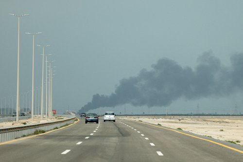 Vehicles move along a road as smoke billows from Saudi Aramco's Ras Tanura oil refinery after a reported Iranian drone strike, amid the U.S.-Israel conflict with Iran, in Ras Tanura, Saudi Arabia, March 2, 2026. REUTERS/Stringer TPX IMAGES OF THE DAY