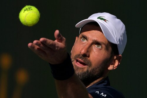 Mar 7, 2026; Indian Wells, CA, USA; Novak Djokovic (SRB) tosses the ball for a serve during his second round match against Kamil Majchrzak (POL) in the BNP Paribas Open at the Indian Wells Tennis Garden. Mandatory Credit: Jayne Kamin-Oncea-Imagn Images