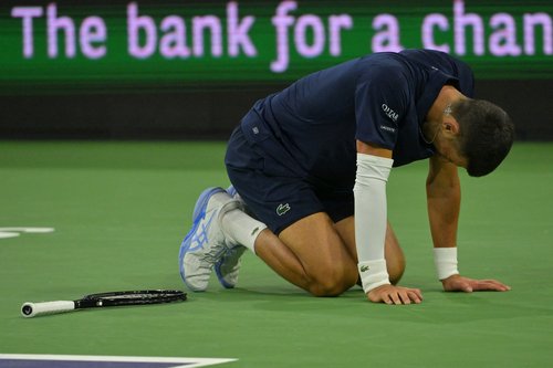Mar 11, 2026; Indian Wells, CA, USA; Novak Djokovic (SRB) kneels on the court after missing a shot during his fourth round match against Jack Draper (GBR) in the BNP Paribas Open at the Indian Wells Tennis Garden. Mandatory Credit: Jayne Kamin-Oncea-Imag