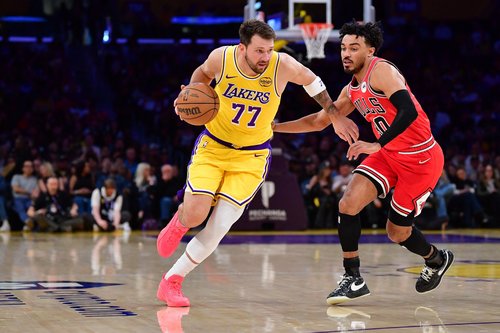 Mar 12, 2026; Los Angeles, California, USA; Los Angeles Lakers guard Luka Doncic (77) moves the ball against Chicago Bulls guard Tre Jones (30) during the first half at Crypto.com Arena. Mandatory Credit: Gary A. Vasquez-Imagn Images