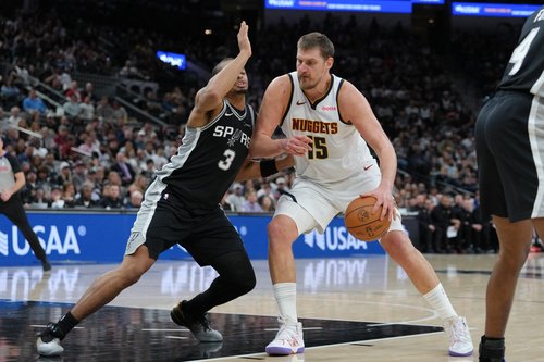Mar 12, 2026; San Antonio, Texas, USA; Denver Nuggets center Nikola Jokic (15) dribbles against San Antonio Spurs forward Keldon Johnson (3) in the first half at Frost Bank Center. Mandatory Credit: Daniel Dunn-Imagn Images