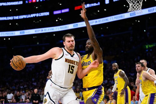 Mar 14, 2026; Los Angeles, California, USA; Denver Nuggets center Nikola Jokic (15) drives the ball while under pressure from Los Angeles Lakers center Deandre Ayton (5) during overtime at Crypto.com Arena. Mandatory Credit: William Liang-Imagn Images