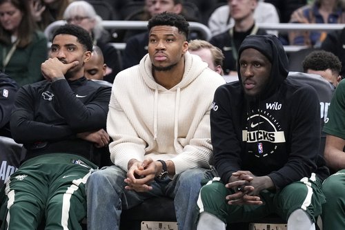 Mar 17, 2026; Milwaukee, Wisconsin, USA; Milwaukee Bucks guard Gary Harris (11), left, Milwaukee Bucks forward Giannis Antetokounmpo (34) and Milwaukee Bucks forward Taurean Prince (12) watch the game against the Cleveland Cavaliers from the bench in the