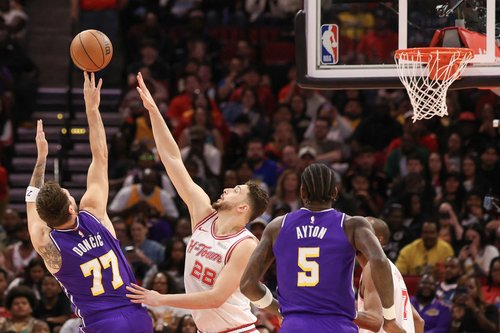 Mar 18, 2026; Houston, Texas, USA; Los Angeles Lakers guard Luka Doncic (77) shoots over Houston Rockets center Alperen Sengun (28) in the first quarter at Toyota Center. Mandatory Credit: Thomas Shea-Imagn Images