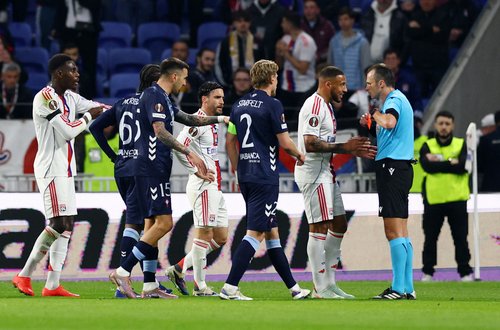 Soccer Football - UEFA Europa League - Round of 16 - Second Leg - Olympique Lyonnais v Celta Vigo - Groupama Stadium, Lyon, France - March 19, 2026 Olympique Lyonnais' Corentin Tolisso speaks to referee Irfan Peljto as he shows Moussa Niakhate a red card