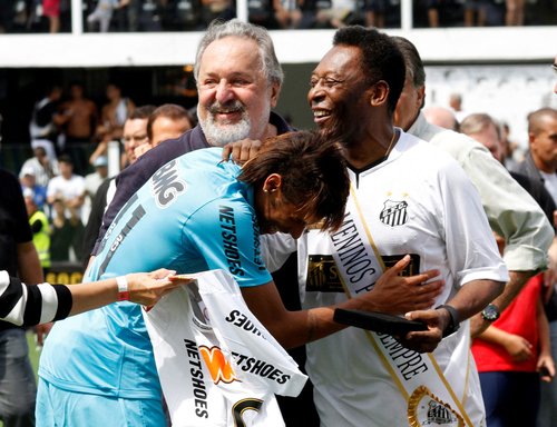 FILE PHOTO: Soccer legend Pele is greeted by Santos' Neymar as Santos FC President Ribeiro looks on during a ceremony in Santos to celebrate the 100th anniversary of Brazilian soccer club Santos