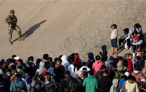 Members of the Texas National Guard stand guard on the banks of the Rio Bravo river, the border between the U.S. and Mexico