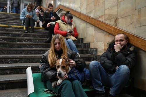 People take shelter inside a metro station during massive Russian missile attacks in Kyiv