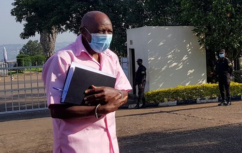 FILE PHOTO: Paul Rusesabagina, portrayed as a hero in a Hollywood movie about Rwanda's 1994 genocide, walks in handcuffs to a courtroom in Kigali