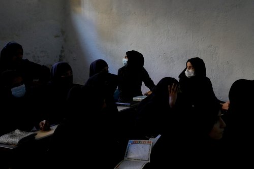 FILE PHOTO: Afghan women learn how to read the Koran in a madrasa or religious school in Kabul