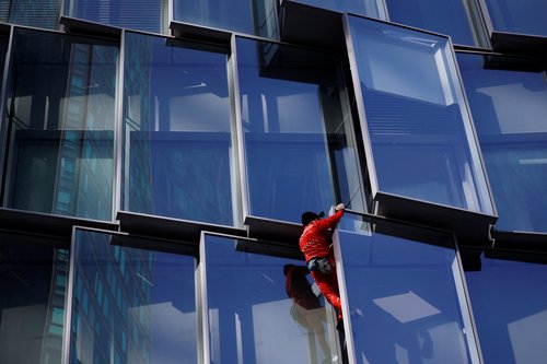 French "Spiderman" Alain Robert scales a skyscraper "for the people" in Paris
