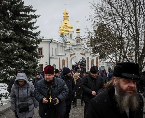 Believers and priests leave a church after a service at a compound of the Kyiv Pechersk Lavra monastery in Kyiv