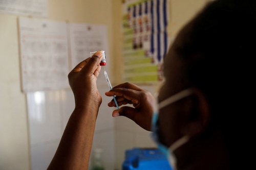 FILE PHOTO: A nurse fills a syringe with malaria vaccine before administering it to an infant at the Lumumba hospital in Kisumu