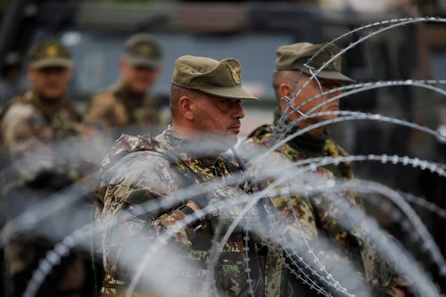Members of the NATO-led Kosovo Force (KFOR) stand guard in Leposavic