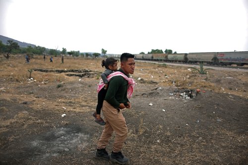 The Wider Image: Migrants risk life and limb to jump Mexico trains in rush to border