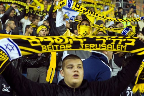 FILE PHOTO: Fans of Beitar Jerusalem shout slogans during a match against Bnei Sakhnin as part of the Israeli Premier League, at Teddy Stadium in Jerusalem