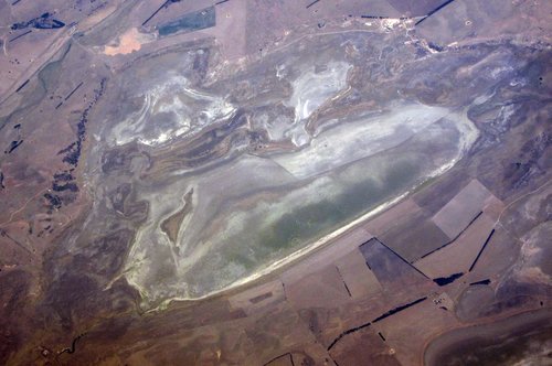 FILE PHOTO: A lake with low levels of water can be seen in a drought affected farming land on the outskirts of Canberra in Australia
