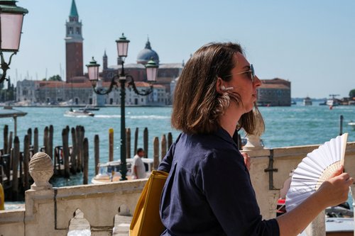 People cool off on a hot day as the city gears up for 'Redentore' festival celebrations in Venice