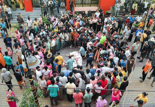 People offer condolence as they gather around the body of a man killed in a violence between ethnic groups in northeastern state of Manipur