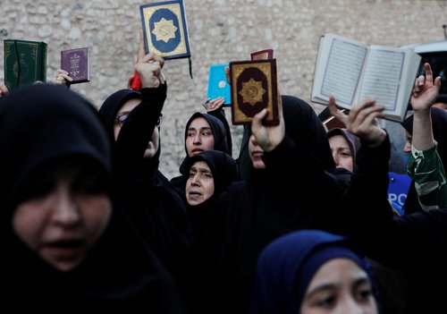 Protesters hold copies of the Koran as they demonstrate outside the Consulate General of Sweden in Istanbul