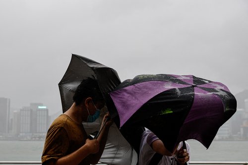 People brave strong winds as Super Typhoon Saola approaches, in Hong Kong