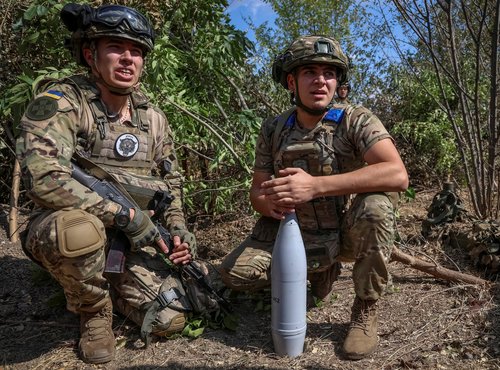 Ukrainian servicemen of the Spartan Brigade of the National Guard of Ukraine prepare a shell for a D-30 howitzer at a position at a front line in Zaporizhzhia region