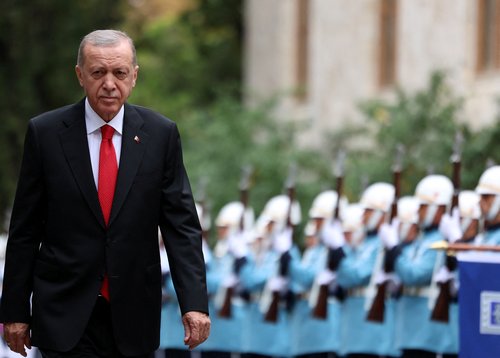 Turkey's President Tayyip Erdogan reviews a guard of honour as he attends the reopening of the Turkish parliament in Ankara