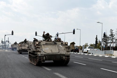 A convoy Armoured Personnel Carriers (APCs) makes their way to Israel's border with Lebanon, in Nahariya, northern Israel