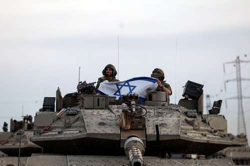 Israeli soldiers bring tanks near Gaza Strip