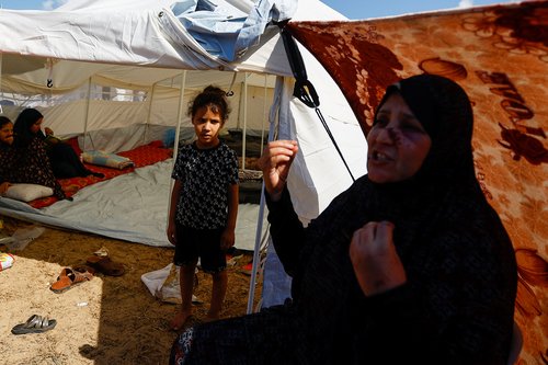 Palestinians, who fled their house amid Israeli strikes, shelter at a United Nations-run centre in Khan Younis