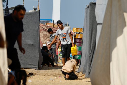 Palestinians take shelter in a tent camp at a United Nations-run centre in Khan Younis