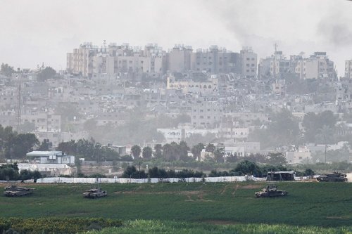 Israeli tanks manoeuvre inside the Gaza Strip, as seen from Israel