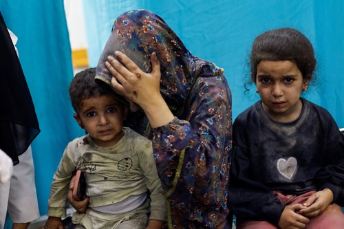 Palestinian children wounded in Israeli strikes wait to receive treatment at Nasser hospital in Khan Younis