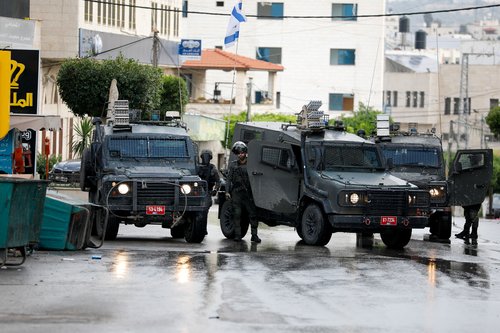 Israeli army vehicles operate during an Israeli raid, in Tulkarm