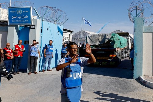 FILE PHOTO: Aid trucks arrive at a UN storage facility in the central Gaza Strip