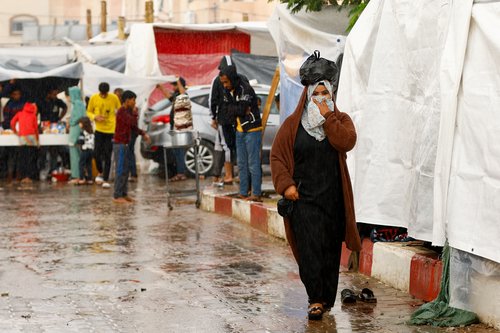 Displaced Palestinians shelter in a tent camp, in Khan Younis