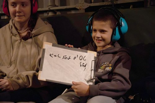 Israeli boy Tal Goldstein-Almog, 9, sits next to an Israeli soldier after being held hostage and released by Hamas
