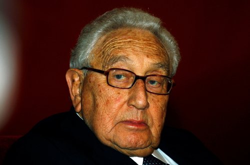 FILE PHOTO: Former U.S. Secretary of State Henry Kissinger listens to Chinese Vice-President Xi Jinping speak in Beijing