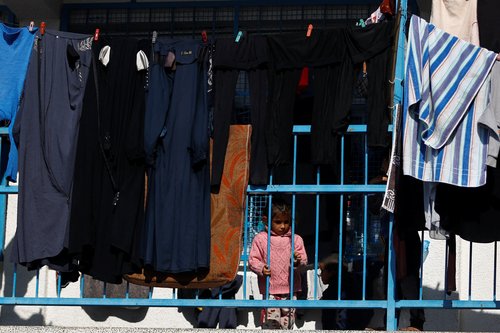 Palestinians, who fled their houses amid Israeli strikes, shelter at a United Nations-run school, in Khan Younis