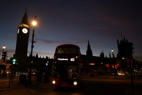 A bus passes near the Houses of Parliament, in London